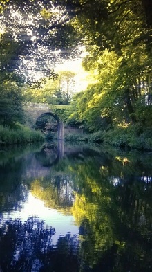 beautiful Lancaster canal bridge reflections with green and yellow foliage